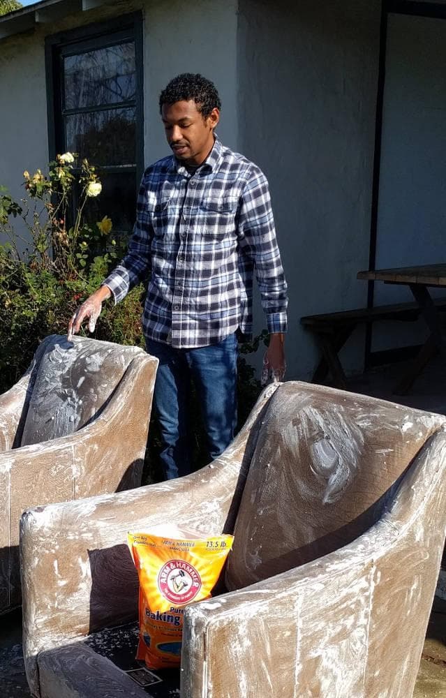 a man washing a chair